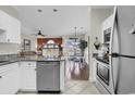 Bright kitchen with stainless steel appliances, granite counters, and open access to the dining and living areas at 699 Riverwalk Dr. # 202, Myrtle Beach, SC 29579