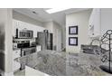 Well-lit kitchen featuring granite countertops, stainless steel appliances, and white cabinetry at 699 Riverwalk Dr. # 202, Myrtle Beach, SC 29579