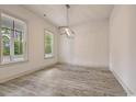 Spacious living room with light gray floors, neutral walls, and modern light fixture at 82 Bridgeview Rd., Georgetown, SC 29440