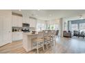 Bright kitchen with white cabinets, stainless steel appliances, island and breakfast bar seating at 929 Maya Layne Dr., Little River, SC 29566