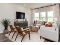 Cozy living room features neutral furniture, a large flat-screen TV, and a decorative coffee table at 933 Maya Layne Dr., Little River, SC 29566