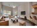 Bright living room featuring high ceilings, modern decor, stylish furnishings, and a walk-out balcony at 999 Algonquin Dr. # E, Pawleys Island, SC 29585