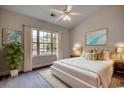 Inviting bedroom featuring a plush bed, ceiling fan, ample natural light, and stylish decor at 999 Algonquin Dr. # E, Pawleys Island, SC 29585
