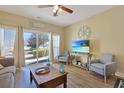 Living room features natural light, slider to outdoor patio, and comfortable seating at 1009 World Tour Blvd. # 103, Myrtle Beach, SC 29579
