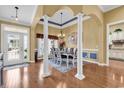 Elegant dining room with hardwood floors, decorative columns, and stylish chandelier, perfect for Gathering gatherings at 120 Henry Middleton Blvd., Myrtle Beach, SC 29588