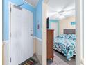 Bright condo bedroom with a queen bed, ceiling fan and a TV at 1210 N Waccamaw Dr. # 212, Garden City Beach, SC 29576