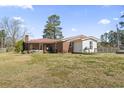 Expansive backyard featuring the home's back exterior with a patio at 1301 Highway 701 South, Loris, SC 29569