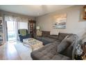 Cozy living room with a large gray sectional sofa, patterned rug, and sliding glass doors to the outside at 1301 Pridgen Rd. # 1101, Myrtle Beach, SC 29577