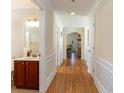 Inviting hallway featuring wood floors, white trim, and views into other rooms at 1341 Brown Pelican Dr., Myrtle Beach, SC 29577