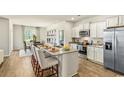 Bright kitchen features stainless appliances, an island with seating, and hardwood floors at 1459 Porchfield Dr., Conway, SC 29526