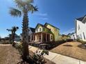 New construction home with bright yellow wrap, front porch, and situated on a grassy lot at 1587 Sayebrook Pkwy., Myrtle Beach, SC 29588