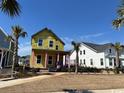New construction home with bright yellow wrap, front porch, and situated on a grassy lot at 1587 Sayebrook Pkwy., Myrtle Beach, SC 29588