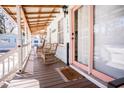 Inviting porch with wicker rocking chairs, ideal for relaxing and enjoying the coastal breeze at 1733 Neptune Rd., Myrtle Beach, SC 29575