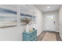Bright entryway featuring wood-look floors, accent cabinet, and a front door with a glass window at 178 Ashworth Dr., Tabor City, NC 28463