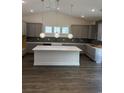 Modern kitchen with gray cabinets, a spacious island, and elegant pendant lighting at 179 Glengrove Lane, Murrells Inlet, SC 29576
