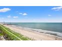 Beautiful ocean view of the beach with blue skies and people walking along the beach at 2000 N Ocean Blvd. # 1509, Myrtle Beach, SC 29577