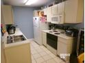 Functional kitchen featuring white cabinetry and appliances, and a double sink at 2257 Huntingdon Dr. # F, Surfside Beach, SC 29575