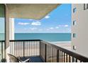 Balcony view with a chair overlooking the beach and ocean at 2311 S Ocean Blvd. # 771, Myrtle Beach, SC 29577