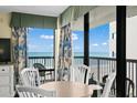 Cozy dining area showcasing ocean views through large windows and balcony doors at 2311 S Ocean Blvd. # 771, Myrtle Beach, SC 29577