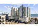 Attractive view of oceanfront hotel with pool, palm trees, and valet parking at 300 N Ocean Blvd. # 324, North Myrtle Beach, SC 29582