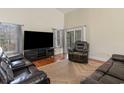 Comfortable living room with plush leather seating, a large TV, and natural light at 321 Cabo Loop, Myrtle Beach, SC 29588
