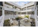 Enclosed multi-story condo courtyard with table, chairs and a small garden at 351 Lake Arrowhead Rd. # 131, Myrtle Beach, SC 29572