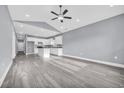 Bright, open-concept living space flows into the kitchen with white cabinets and a central island at 3837 Mayfield Dr., Conway, SC 29526