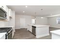 Modern kitchen with stainless steel appliances, center island with sink and pendant lighting at 6055 Forest Dell Ct, Myrtle Beach, SC 29579