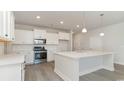 Bright kitchen featuring stainless steel appliances, white cabinets, and an island with seating at 6055 Forest Dell Ct, Myrtle Beach, SC 29579