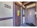 Condo entrance with unit number, pineapple decor, and a front door with a window at 6813 Porcher Dr. # 26, Myrtle Beach, SC 29572