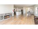 Open-concept living room with hardwood floors, a fireplace, and access to the kitchen and dining area at 723 Joywood Dr., Longs, SC 29568