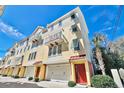 Beautiful multi-story townhouse featuring private balconies, individual garages, and colorful exterior at 7401 N Ocean Blvd. # 5, Myrtle Beach, SC 29572