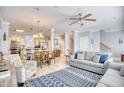 Cozy open-concept living room flowing into kitchen, tile flooring, ceiling fan, and comfortable seating at 7401 N Ocean Blvd. # 5, Myrtle Beach, SC 29572