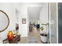 Bright entryway with light wood flooring, light walls and stylish decor leads into the home at 781 Flowering Branch Ave., Little River, SC 29566