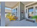 Inviting front porch with ample seating and a charming welcome sign at 892 Harrison Mill St., Myrtle Beach, SC 29579