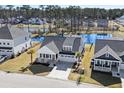 Aerial view of the home, showcasing its manicured lawn and the nearby community pond at 9035 Binnicker Dr., Murrells Inlet, SC 29576
