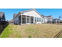 Expansive backyard with a screened-in porch and black metal fence at 9035 Binnicker Dr., Murrells Inlet, SC 29576