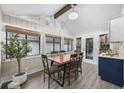 Cozy dining area with a wooden table, modern chairs, large windows, and ample natural light at 954 Oakwood Ln., Myrtle Beach, SC 29572