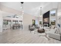 Bright and airy living room with fireplace, modern furnishings, and sleek flooring connected to open dining space at 954 Oakwood Ln., Myrtle Beach, SC 29572