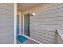 View of the condo's exterior entrance door with adjacent door and muted green, neutral, and gray color scheme at 1113 N Ocean Blvd. # 101, Surfside Beach, SC 29575