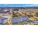 A beautiful aerial view of the building with surrounding lake, parking, and scenery at 131 Waypoint Ridge Ave. # Q29, Little River, SC 29566