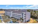 Corner of a condo building with balconies, landscaping, and dedicated parking spaces at 131 Waypoint Ridge Ave. # Q29, Little River, SC 29566