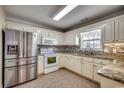 Bright kitchen featuring stainless steel appliances, granite countertops, and white cabinetry at 1525 Sunmeadow Dr., Conway, SC 29526