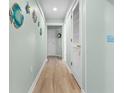 Hallway with light wood floors and coastal-themed decor at 180 Rothbury Circle # 302, Myrtle Beach, SC 29572