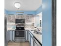 Charming kitchen featuring stainless steel appliances and coastal-themed decor at 180 Rothbury Circle # 302, Myrtle Beach, SC 29572