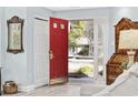 Bright entryway featuring red front door, hardwood floors, and elegant furnishings at 1820 Spinnaker Dr., North Myrtle Beach, SC 29582
