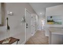 Inviting hallway with neutral tones, coastal decor, and tiled floors leading to other rooms at 2000 N Waccamaw Dr., Garden City Beach, SC 29576