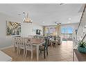 Open-concept living and dining area featuring tile floors and sliders to the outdoor deck and ocean views at 2000 N Waccamaw Dr., Garden City Beach, SC 29576