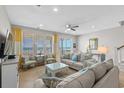 Comfortable living room featuring plush sofas, stylish decor, tile flooring, and beautiful ocean views at 2000 N Waccamaw Dr., Garden City Beach, SC 29576