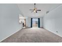 Spacious living area with neutral carpet, high ceilings, and sliding glass doors at 206 Balsa Dr., Longs, SC 29568
